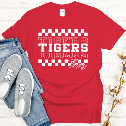 Red t-shirt with 'Tigers Tigers Tigers' text on a white wooden surface with jeans and shoes.