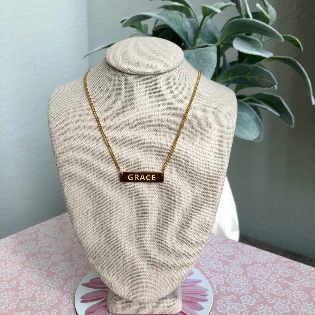 Gold necklace with the word Grace inscription