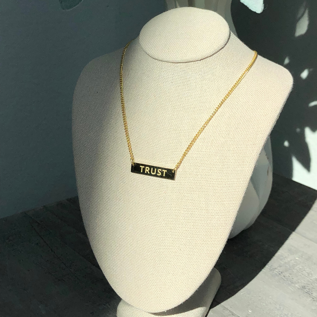 Gold plated necklace with word trust