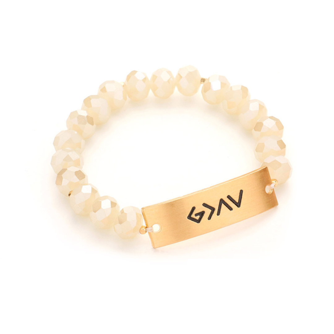 A photo of a stretchy bracelet with gleaming faceted beads, displaying the faith-inspired phrase "God is greater than the highs and lows".