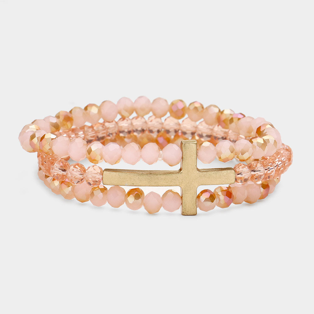 Pink faceted beaded bracelet with elegant metal cross detail